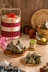 Fototapeta na wymiar Zongzi or Bakcang is a traditional Chinese rice dish made of glutinous rice stuffed with different fillings and wrapped in bamboo leaves. They are cooked by steaming or boiling