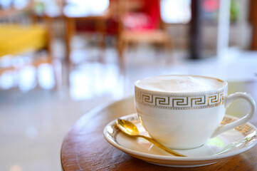 White classic cup of fresh brewed coffee on wooden table in cafe with copy space. Coffee break recreation relaxation
