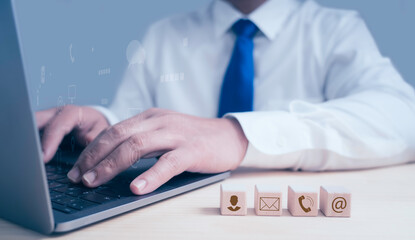 Businessman working on laptop searching web, browsing information with contact icons, Business contact concept