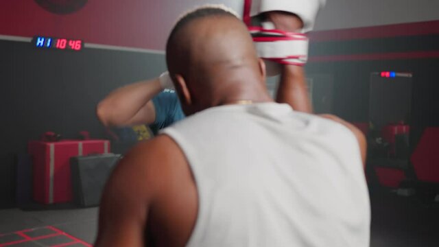 Fitness boxer trainer motivate sportsman exercise boxing, punch at gym