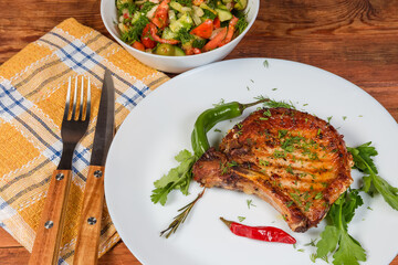 Serving of grilled pork loin chop bone-in close-up