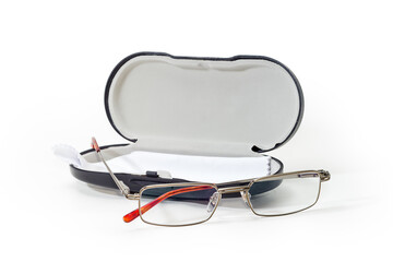 Eyeglasses for men against hard spectacle-case on white surface
