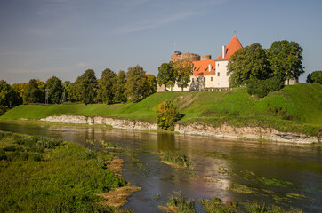 Fototapeta na wymiar Bauska city castle in Latvia up in the hill. Sunny autumn day.