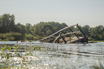 Floods in the city of Bauska, Latvia. A small wooden bridge partially under water.