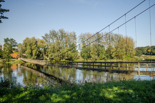 Wooden pedestrian bridge over Memele river, Bauska, Latvia.