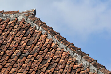 Traditional tile roof in a village in Indonesia with blue sky