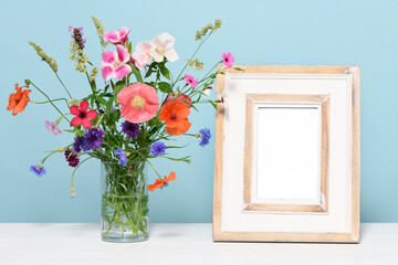 Empty wooden frame with flowers