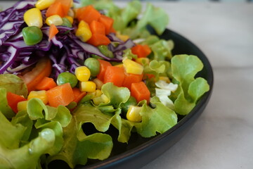 Vegetable salad and green lettuce spinach, cherry tomatoes, corn salad, baby spinach, fresh mint and basil.  Selective focus