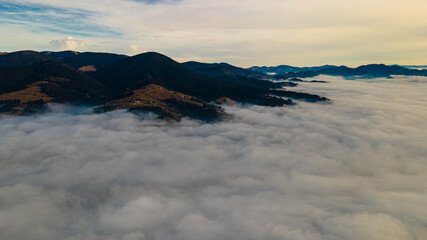 Fototapeta na wymiar mountains tops high above clouds fog
