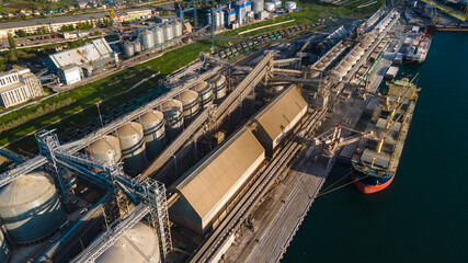 Industrial port in the field of import-export global business logistics and transportation, Loading and unloading container ships, cargo transportation from a bird's eye view.