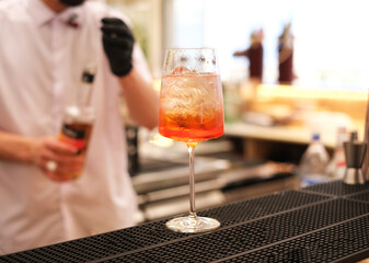 the bartender makes a cocktail in the restaurant at the bar. refreshing summer drinks. bartender at work close-up. mockup