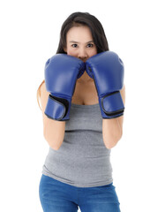 Confident sportive woman in boxing gloves