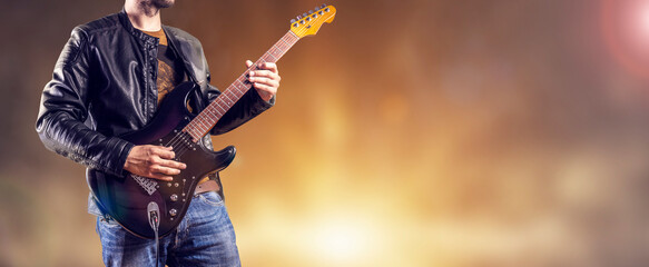 Rock guitarist plays an electric guitar. Artist and musician performs like rockstar. Guitar player...