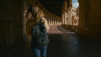 Camera follows young female student who walks through corridors of university campus. Excited new freshman on way to first lecture class. Education and international student exchange