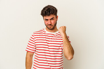 Young caucasian man isolated on white background showing fist to camera, aggressive facial...