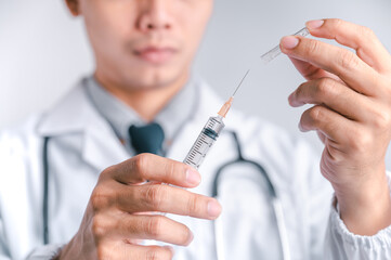 Doctor or scientist carries a syringe and a vaccine against COVID-19, vaccination and laboratory...
