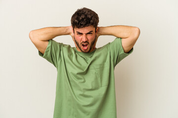 Young caucasian man isolated on white background screaming with rage.