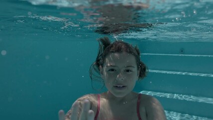 girl swimming in a pool in summer