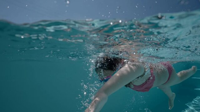 girl swimming in a pool in summer