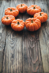 Autumn composition of miniature decorative pumpkins on a wooden table.