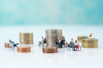 Euro coins and miniature people close up