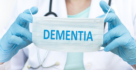 Doctor holding a face shield with text DEMENTIA, medical concept