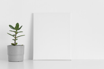 White canvas mockup with a succulent plant on the table.