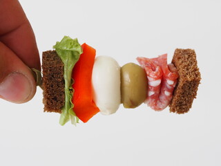small sandwiches on toothpicks canapes in hand