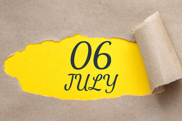 july 06. 06th day of the month, calendar date.Hole in paper with edges torn off. Yellow background is visible through ragged hole.Summer month, day of the year concept