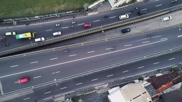 Top down aerial view of highway road with multi lane and busy traffic