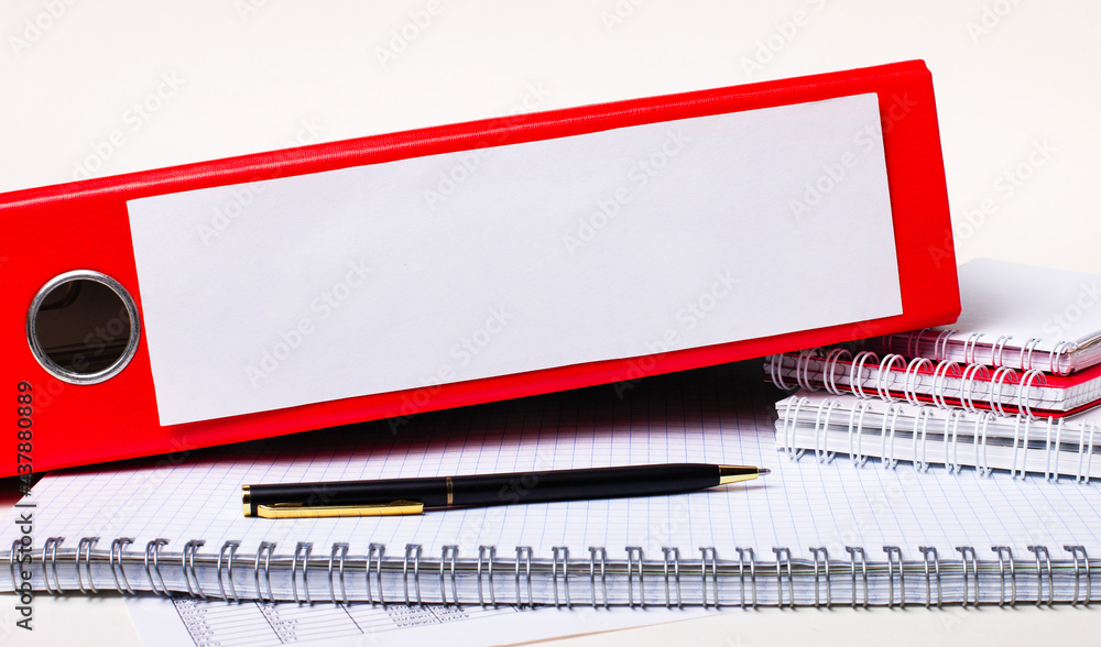 Poster on the desktop are notepads, a pen and a red folder for papers with a place to insert text. template