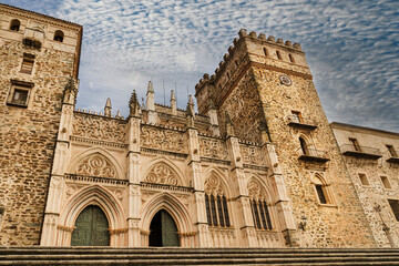 Main facade of the Mudejar Gothic Monastery of Guadalupe in Spain. World heritage - obrazy, fototapety, plakaty