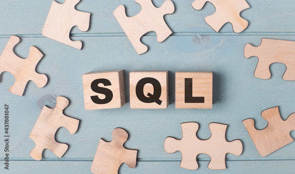 Poster blank puzzles and wooden cubes with the text sql structured query language lie on a light blue backg