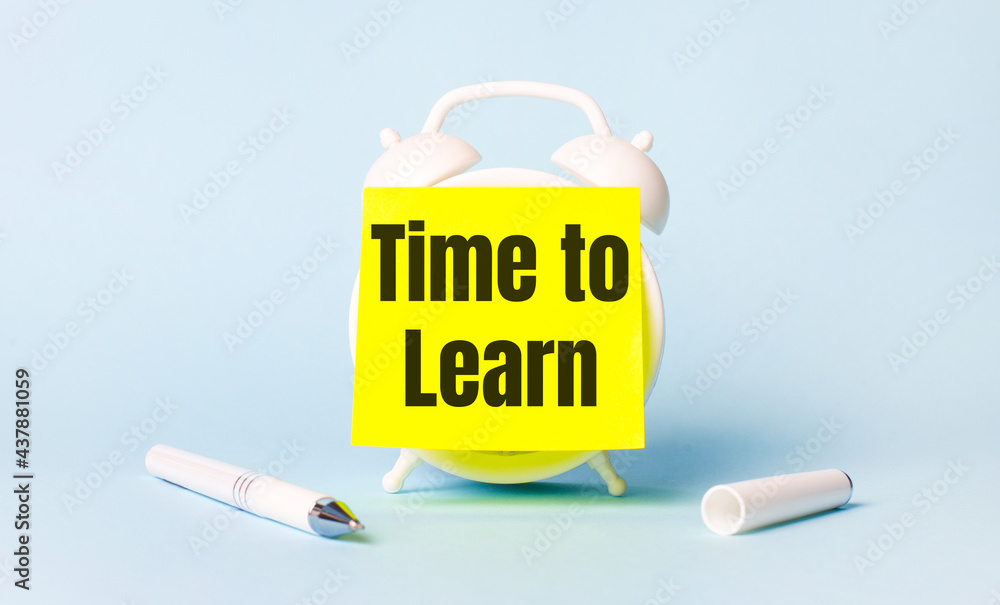 Poster on a light blue background - a white handle and an alarm clock with a bright yellow sticker glued to