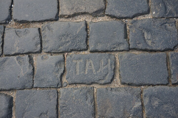 Three carved letters on paving stones on Red Square. Moscow, Russia.