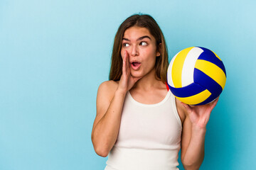 Young caucasian woman playing volleyball isolated on blue background is saying a secret hot braking...