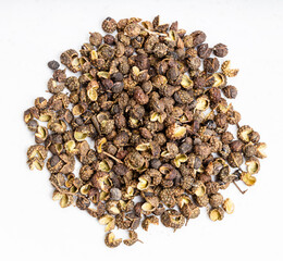 sichuan pepper peppercorns close up on gray