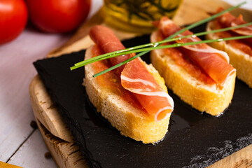 Spanish snack with bread, tomato ham and olive oil