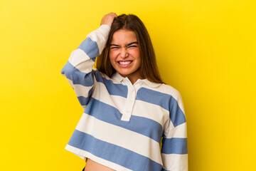 Young caucasian woman isolated on yellow background forgetting something, slapping forehead with...