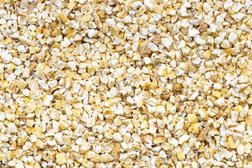 background - uncooked crushed pot barley groats