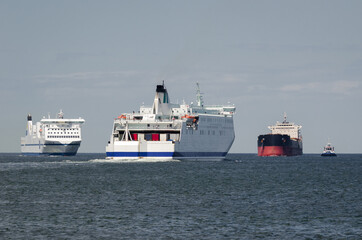 Naklejka premium MARITIME TRANSPORT - Passenger ferrys and bulk carrier on waterway to the port 