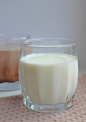 milk and cocoa in glasses on a beige napkin