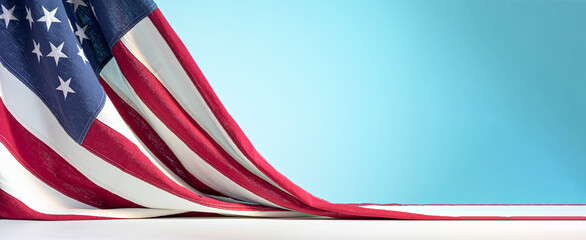 United States of America flag on white table on blue sky background. Celebration of the Fourth of...