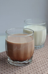 milk and cocoa in glasses on a beige napkin