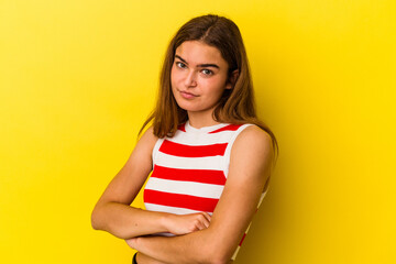 Young caucasian woman isolated on yellow background unhappy looking in camera with sarcastic expression.