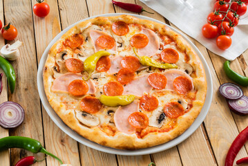 tasty pizza on the wooden background
