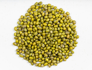 pile of raw green mung beans close up on gray