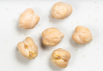 several raw dried chickpea seeds close up on gray