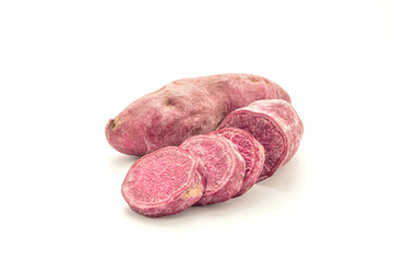 Purple yams or purple sweet potatoes isolated on white background. Side view. Vegan fruit and healthy fruits concept