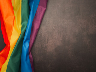 Top view of the rainbow flag (LGBT) on vintage background. Top view. Flat lay. Space for text. Love concept